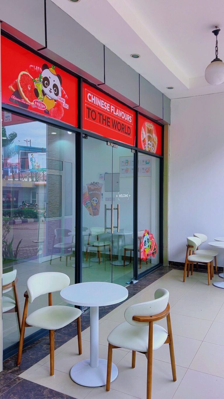 Seating area with tables and chairs inside VMAX365 Tea & Coffee, Shamo Tower, Mbezi Beach