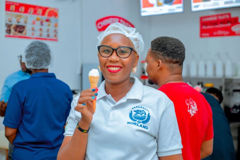 VMAX365 staff member holding a soft-serve ice cream cone, Shamo Tower, Mbezi Beach